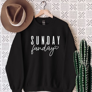 May include: Black sweatshirt with white text that reads "SUNDAY funday" with a small heart symbol.
