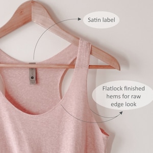 May include: A pink tank top with a satin label and flatlock finished hems for a raw edge look.