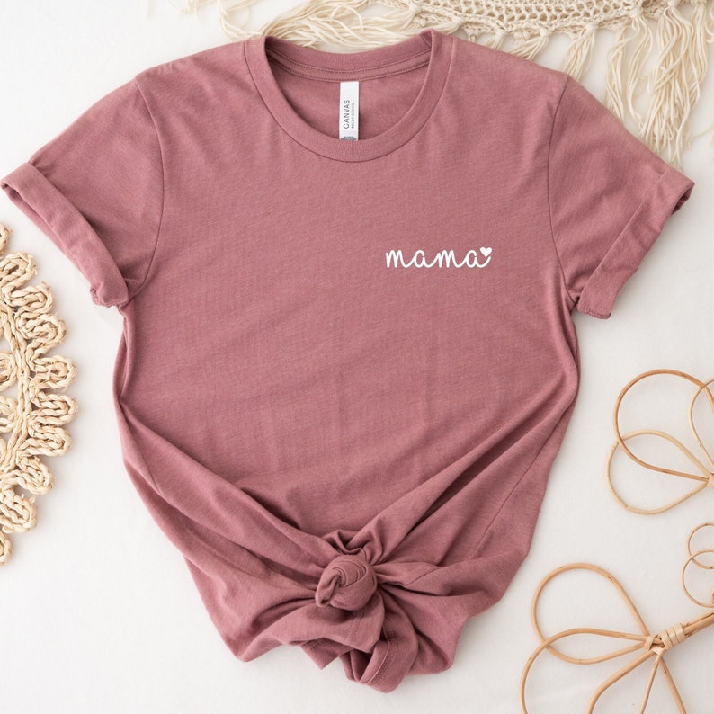 A mauve t-shirt with a white pocket design mama with a cute  heart. Mama Pocket Design T-Shirt Minimalist Mom Gift Cute Boy Mom Shirt Trendy Girl Mama Apparel Mothers Day Gift Bella Canvas Shirt