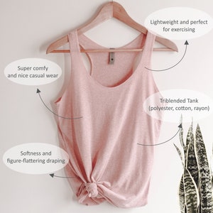 May include: A light pink triblend tank top made of polyester, cotton, and rayon, hanging on a wooden hanger. The tank top has a racerback design and is knotted at the bottom. The image text says it is lightweight and perfect for exercising.