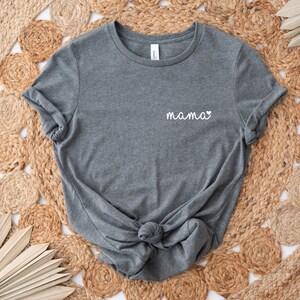 A heather gray t-shirt with the word "mama" and a small heart pocket design  on the front. Mama Pocket Design TShirt Minimalist Mom Gift Cute Boy Mom Shirt Trendy Girl Mama Apparel Mothers Day Gift Bella Canvas Shirt