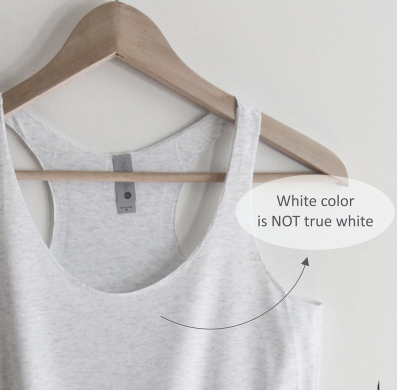 May include: A white tank top hanging on a wooden hanger. The white colour is not true white.