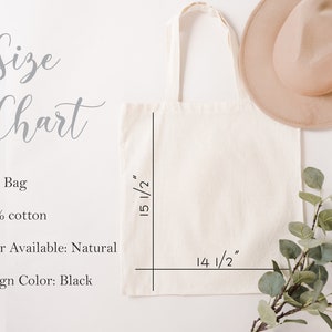 Peut inclure: Un sac fourre-tout de couleur naturelle en 100 % coton. Le sac mesure 14 1/2 pouces de large et 15 1/2 pouces de haut. Le texte "Size Chart" est &eacute;crit en cursive au-dessus du sac. Le sac est sur une surface blanche.