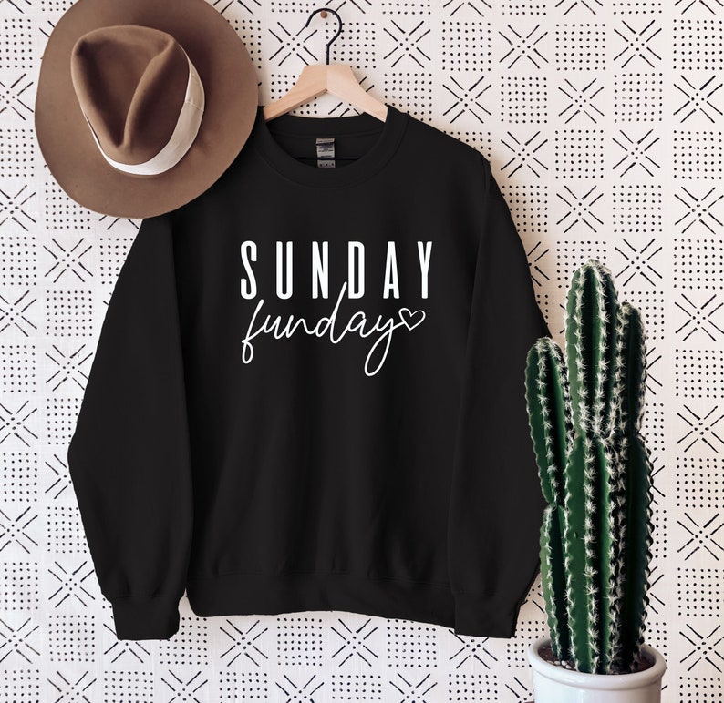 May include: Black sweatshirt with white text that reads "SUNDAY funday" with a small heart symbol.
