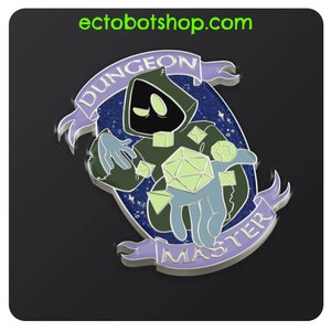May include: A pin featuring a hooded figure with glowing eyes and hands, holding dice. The design includes the words "DUNGEON MASTER" on a banner, set against a starry background. The website ectobotshop.com is displayed at the top.