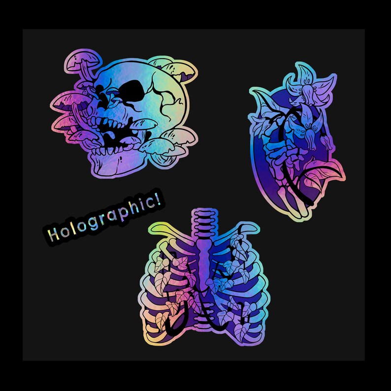 May include: Three holographic stickers featuring a skull surrounded by mushrooms, a floral design with a skeletal hand, and a ribcage with vines growing through it. The text "Holographic!" is on the sticker with the skull.