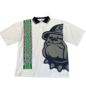 May include: White short-sleeved polo shirt with a green and black stripe down the left side. The shirt features a large graphic of a bulldog wearing a hat and a collar with spikes. The text "GEORGETOWN" is printed vertically on the stripe.