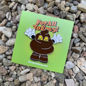 May include: A brown and yellow enamel pin with a cartoon poop emoji wearing white gloves and brown shoes. The pin says "For All To Envy!" and "ForAllToEnvy.com" on the bottom.