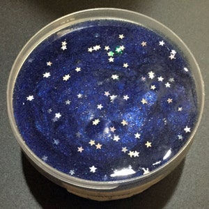 Starry Night - A clear glue based slime with holo stars throughout.  Comes with a glittery star charm