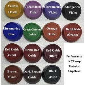 May include: A collection of 12 small round containers of different colors, each containing a different type of pigment. The containers are labeled with the pigment name and color. The text "Performance in CP soap Tested at 2 tsp/lb oil" is written below the containers.