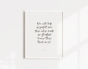 May include: A white framed print with a black and white inspirational quote: "You will keep in perfect peace those whose minds are steadfast because they trust in you." The quote is attributed to Isaiah 26:3.
