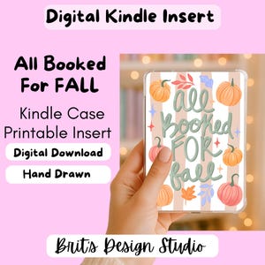 May include: A digital Kindle insert featuring the text All Booked For Fall in sage green script. The design includes orange and pink pumpkins, small leaves, and star accents over a background of vertical beige stripes on a clear e-reader case.