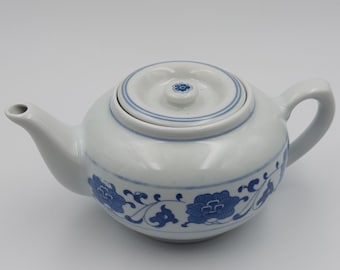 Hand-painted Chinese porcelain teapot with blue floral decoration
