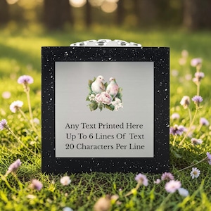 May include: A black framed sign with a speckled border. The sign features a watercolour image of two doves and flowers. Text on the sign reads: "Any Text Printed Here Up To 6 Lines Of Text 20 Characters Per Line."