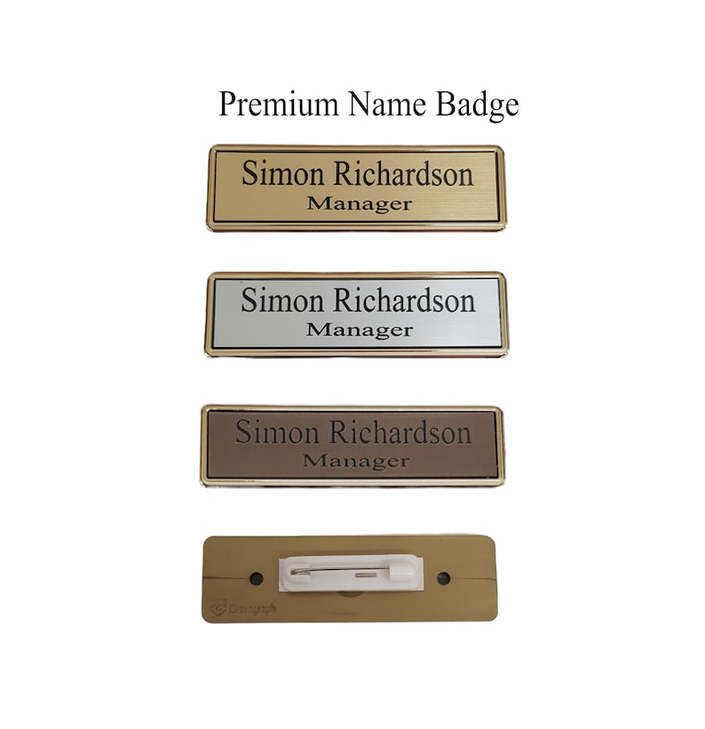 May include: Three gold-colored name badges with the text "Simon Richardson Manager" and a brown name badge with the text "Simon Richardson Manager". The badges are on a white background.