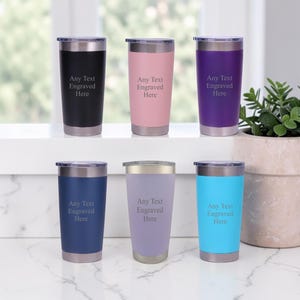 May include: Six insulated tumblers in various colours: black, pink, purple, navy blue, lavender, and turquoise. Each tumbler has a silver rim and lid, with the text "Any Text Engraved Here" printed on the front.