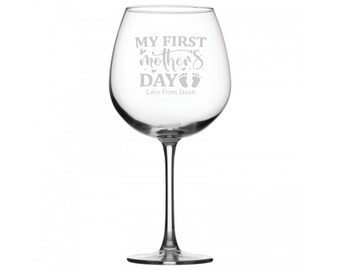 May include: A clear glass wine glass with the text "My First Mother's Day" and "Love From Jaxon" etched on the front.