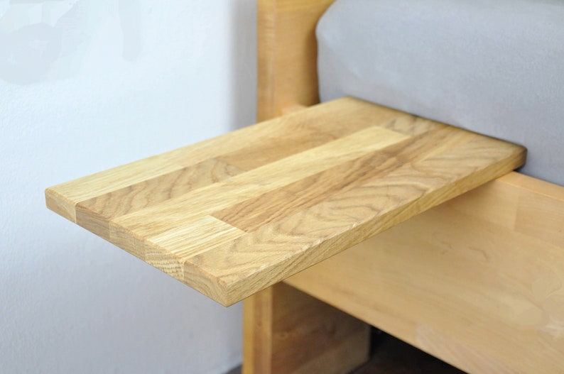 May include: A wooden bedside table with a pull-out tray. The tray is made of light wood and has a natural finish.