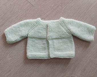 Jacket in mint green with button fastening. Acrylic yarn and machine washable. To fit medium premature baby or 16 inch reborn baby or doll