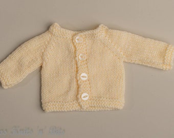 Handknitted cardigan in Cream colour for 16 inch doll or medium premature baby. Acrylic yarn and machine washable