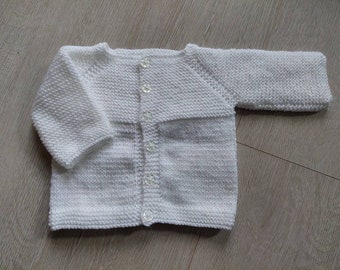 Jacket in white to fit 6-9 months with front button fastening