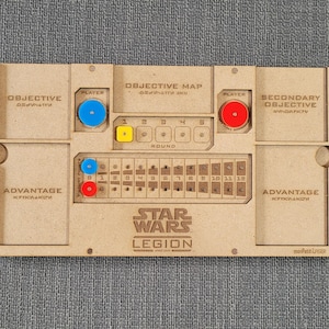 May include: A wooden game board for the Star Wars: Legion board game. The board has spaces for objective cards, secondary objective cards, advantage tokens, and a round tracker. The board also has spaces for dice and a map.