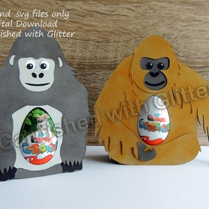 May include: Two digital cut files for a gorilla and an orangutan holding a chocolate egg. The files are for crafting and are available for digital download. The text "Garnished with Glitter" is on the image.