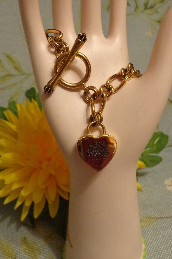 Buy the Designer Juicy Couture Gold-Tone Toggle Heart Charm Chain Bracelet  With Box