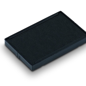 May include: A black ink pad for stamping, with a rectangular shape and a textured surface.