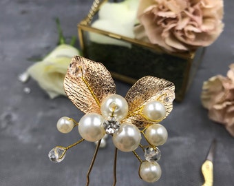May include: Gold hair pins with pearl and crystal accents, shaped like leaves.