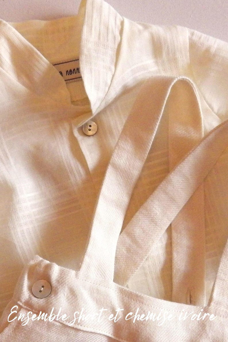 May include: A white linen shirt with a button closure and a white linen overall with straps. The text "Ensemble Shirt et chemise noire" is visible on the overall.