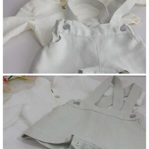 May include: Two sets of baby overalls. The first set is white with a white button-down shirt. The second set is light green with a white button-down shirt.