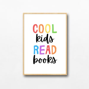 May include: A framed print with the text "COOL kids READ books" in rainbow colors. The text is in a playful, handwritten font.