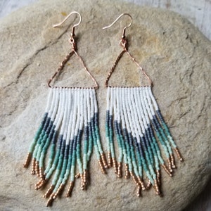 Sunkissed Ocean Wave woven seed beaded fringe earrings dangling from handmade hammered copper triangle