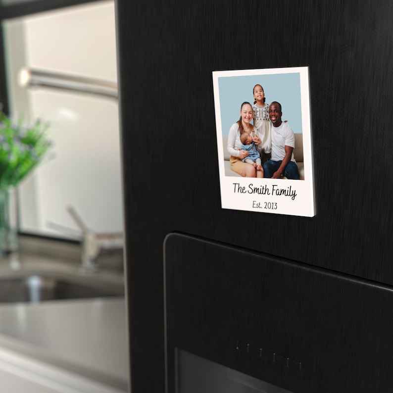 May include: A white photo frame with a picture of a family of four. The frame has a white border and the text "The Smith Family Est. 2013" printed on the bottom.