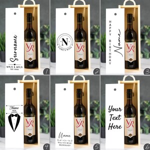 May include: Six different designs for a personalized wine gift box. The box is made of wood and has a white label with a variety of text and designs. The box contains a bottle of red wine.