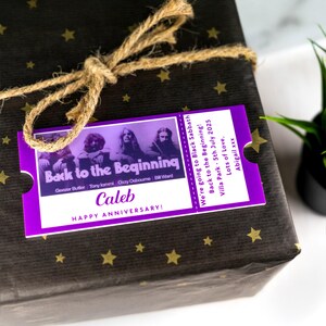 May include: Purple gift tag with a black and white photo of the band Black Sabbath. The text on the tag reads "Back to the Beginning!" and "We're going to Black Sabbath! Back to the Beginning! Villa Park - 5th July 2025 Lots of Love, Abigail xxx". The tag also has the text "Caleb HAPPY ANNIVERSARY!" printed on it.