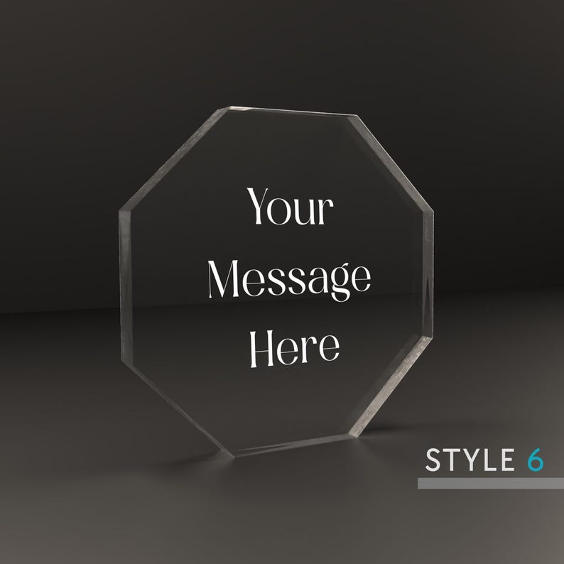 May include: A clear octagonal acrylic plaque with the text "Your Message Here" engraved on the front. The plaque is sitting on a black surface. STYLE 6 is printed in the bottom right corner.