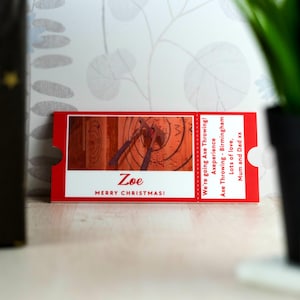 May include: Red and white gift certificate for an axe throwing experience. The certificate says "We're going Axe Throwing!" and "Axeperience Axe Throwing - Birmingham". It also says "Zoe Merry Christmas!" and "Lots of love, Mum and Dad xx".