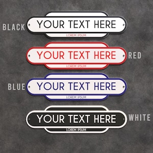 May include: Four custom street signs in black, red, blue, and white. Each sign has a white background with the text "YOUR TEXT HERE" and "LOREM IPSUM". The signs are oval-shaped with rounded corners and are mounted with silver rivets.