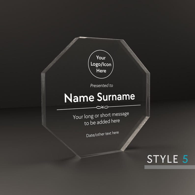 May include: A clear octagonal acrylic award plaque with a white inscription. The inscription reads "Your Logo/Icon Here", "Presented to", "Name Surname", "Your long or short message to be added here", and "Date/other text here".