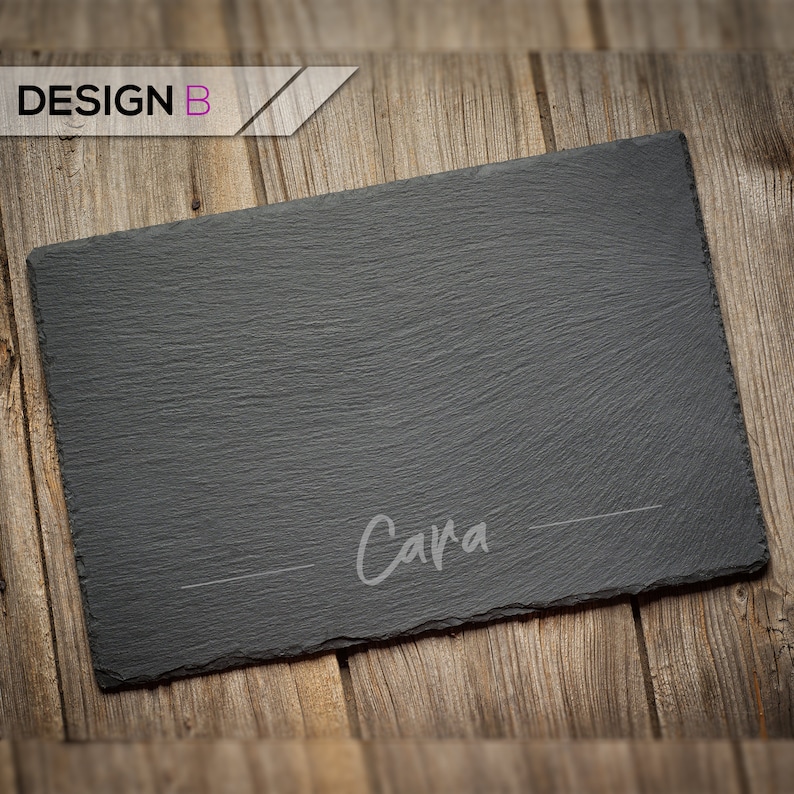 May include: Black slate serving board with the name "Cara" written in white on the surface.