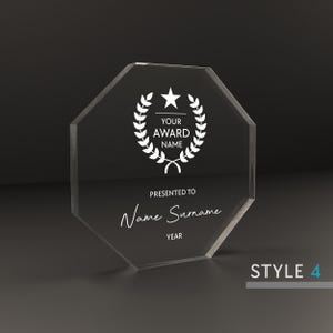 May include: A clear octagonal acrylic award plaque with a white star and laurel wreath design. The text "YOUR AWARD NAME" is printed above the text "PRESENTED TO Name Surname YEAR".