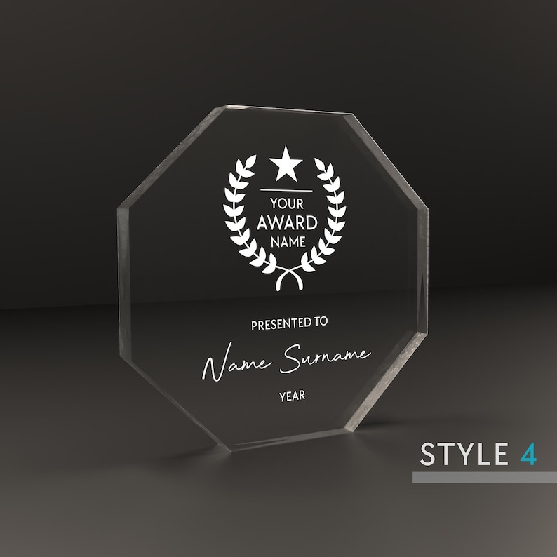 May include: A clear octagonal acrylic award plaque with a white star and laurel wreath design. The text "YOUR AWARD NAME" is printed above the text "PRESENTED TO Name Surname YEAR".