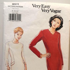 May include: A Very Easy Very Vogue sewing pattern envelope 9511 for sizes 8-10-12. The illustration shows two dress variations: a cream-coloured dress with a round neckline and a red dress with a V-neckline, both featuring long sleeves.