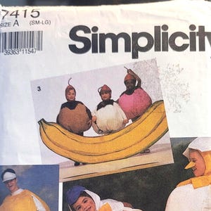 May include: Simplicity sewing pattern 7415, size A (SM-LG), featuring illustrations of various food-themed costumes including a banana, a lemon, an egg, and a character with a round body, a blue hat, and a yellow bow tie, all on a white background.