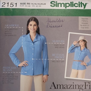 May include: Simplicity sewing pattern 2151 for a button-front blouse. The pattern features princess seams and is designed for sizes 14-22. The image shows a woman wearing a light blue blouse with long sleeves. The pattern includes multiple views.