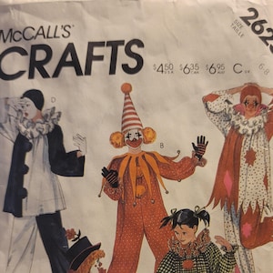 May include: A vintage McCall's Crafts pattern envelope showing illustrations of clown costumes. The designs include various clown outfits with different colours and patterns, including polka dots, checks, and stripes. The text on the envelope includes the word "COSTUMES".