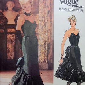 May include: Vogue Patterns Designer Original sewing pattern featuring a strapless evening gown with a ruffled hem and a bow detail. The pattern includes a drawing of the dress and the text "Bellville Sassoon". Pattern number 1471.