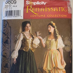 May include: Simplicity Renaissance Costume Collection pattern featuring two women in period dresses. One dress is green and gold, the other is yellow and orange. The pattern includes sizes 4, 6, and 8.